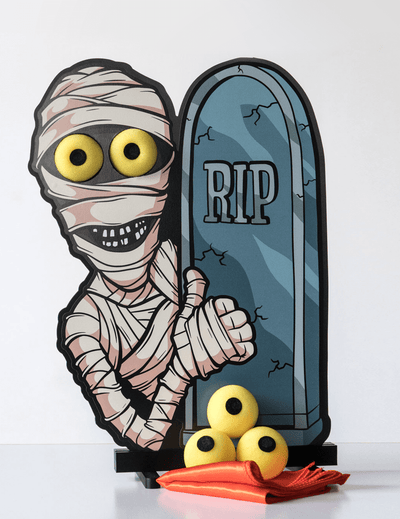 Halloween-themed trick with mummy and tombstone on a white background