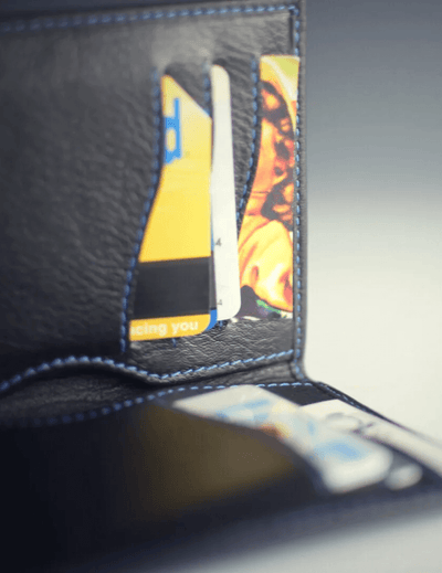 Close-up of a black leather wallet with cards inside