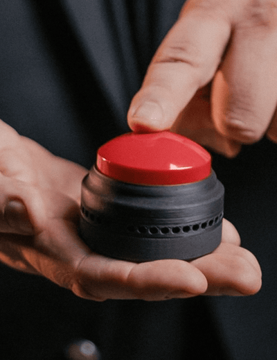 Person holding The Button